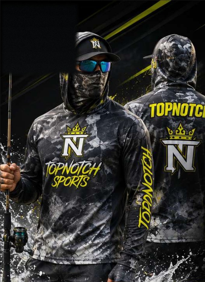 Angler in a black camo Top Notch Sports mask hood fishing shirt holding a fishing rod